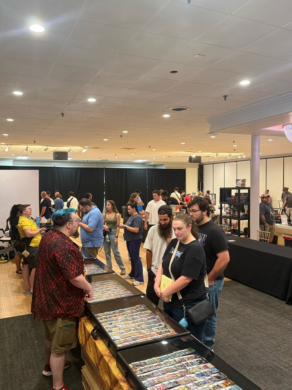 Collectors browsing display cases full of trading cards